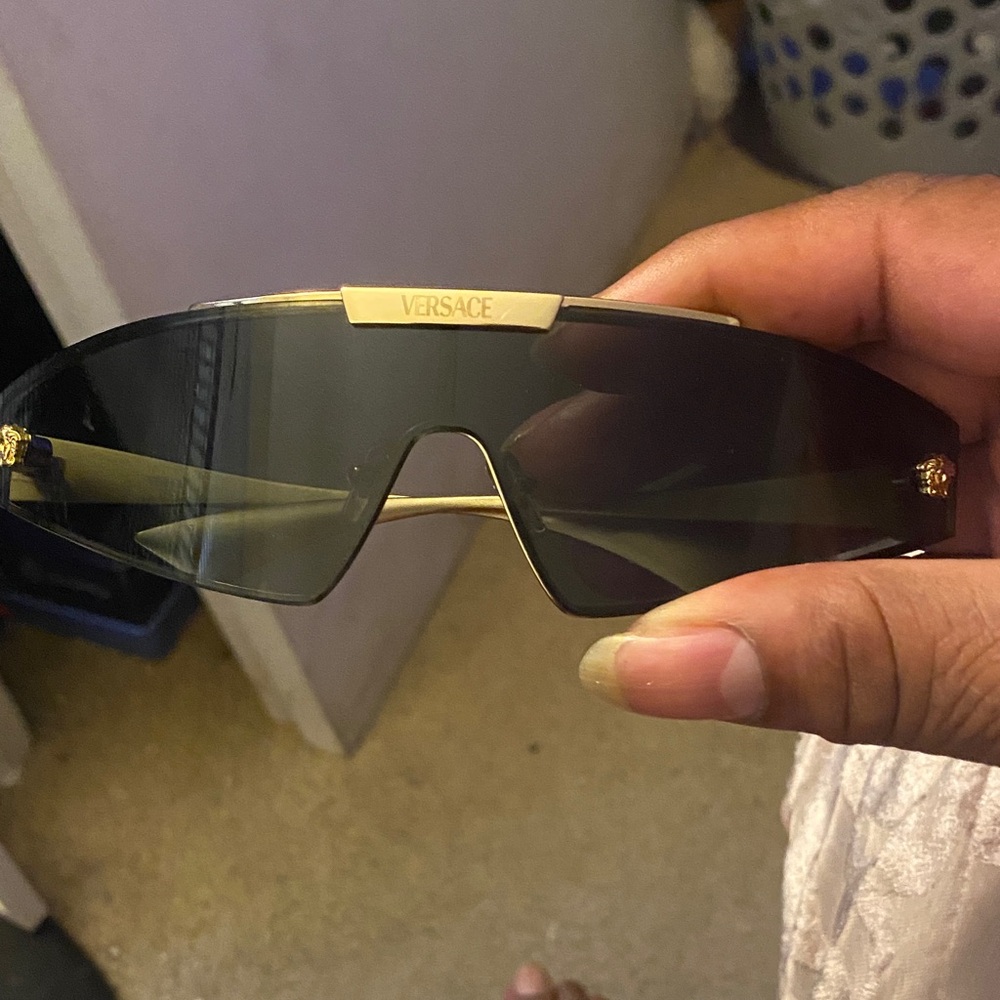 Versace Men's Sunglasses with Black Frame and Gold Details very good condition .